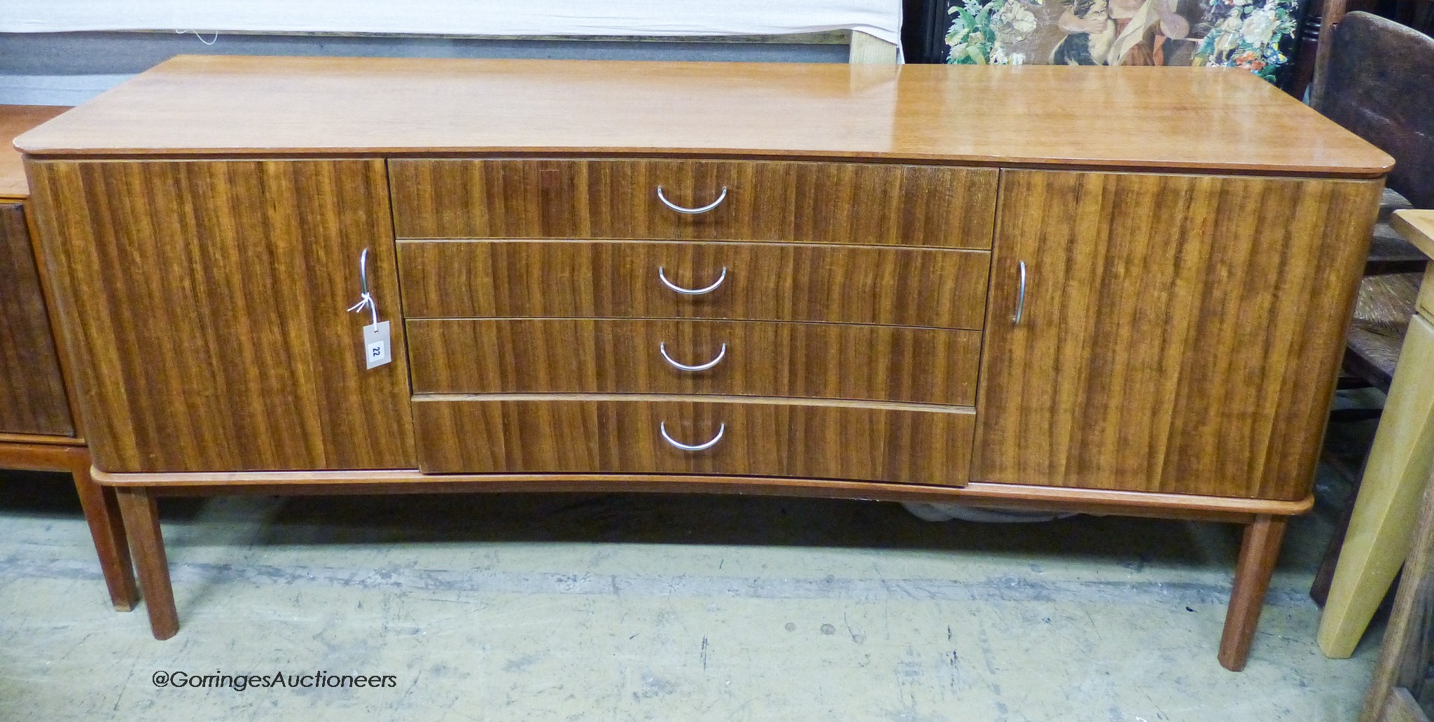 A Gordon Russell Ltd teak and Indian Laurel concave sideboard Model R810 circa 1960, length 183cm, depth 49cm, height 86cm